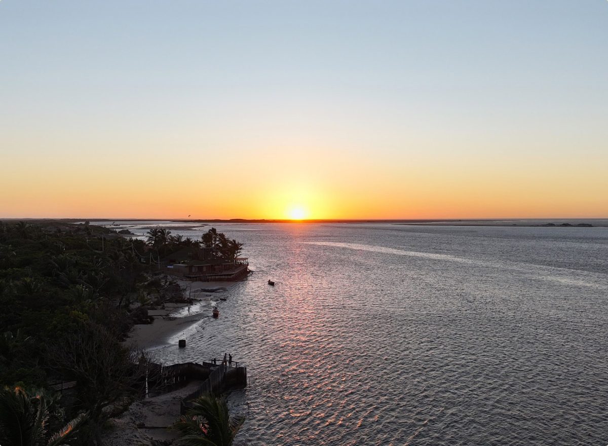Vista aérea do Rancharia Charme Beach no pôr do sol, entre o Rio Preguiças e o mar